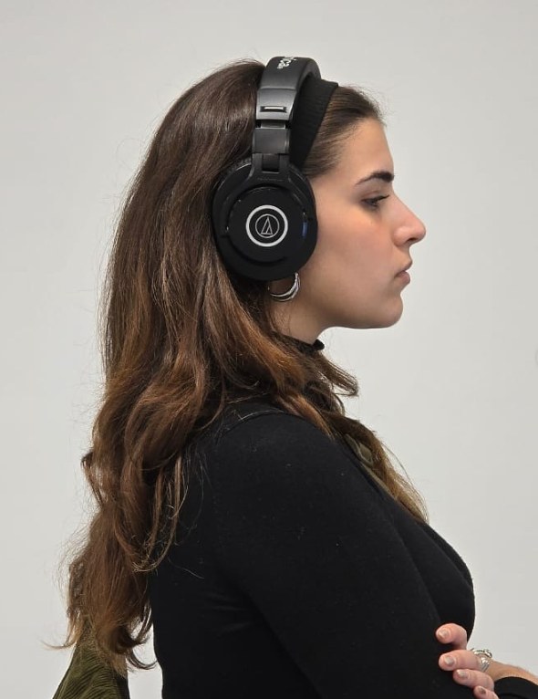 Athina Lasithiotaki in profile, wearing headphones